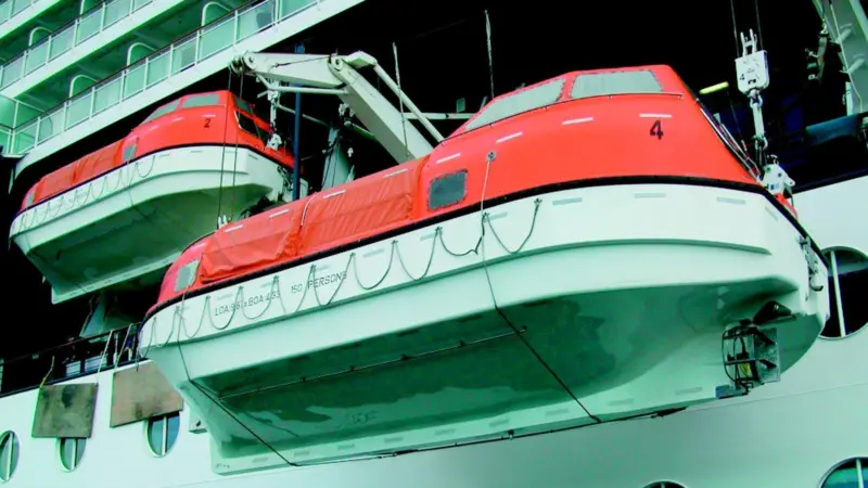 Two of the Millennium lifeboats are hoisted on their new hooks.
