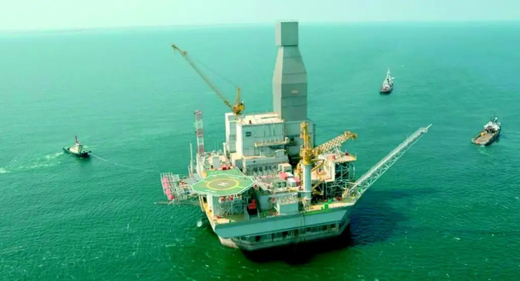 Crowley tugs are seen during set-down operations for the massive Orlan structure.