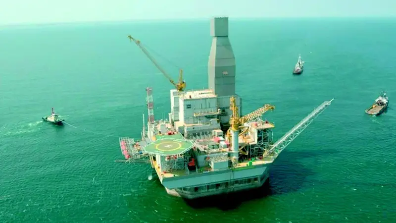 Crowley tugs are seen during set-down operations for the massive Orlan structure.