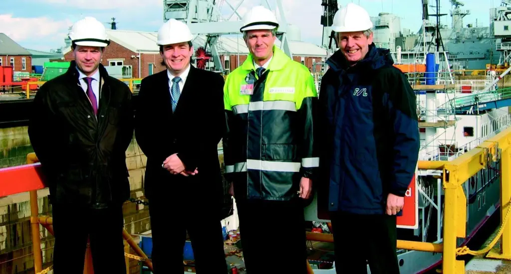 Executives from FSL and Wightlink Marine are seen with the ferry Cenred.