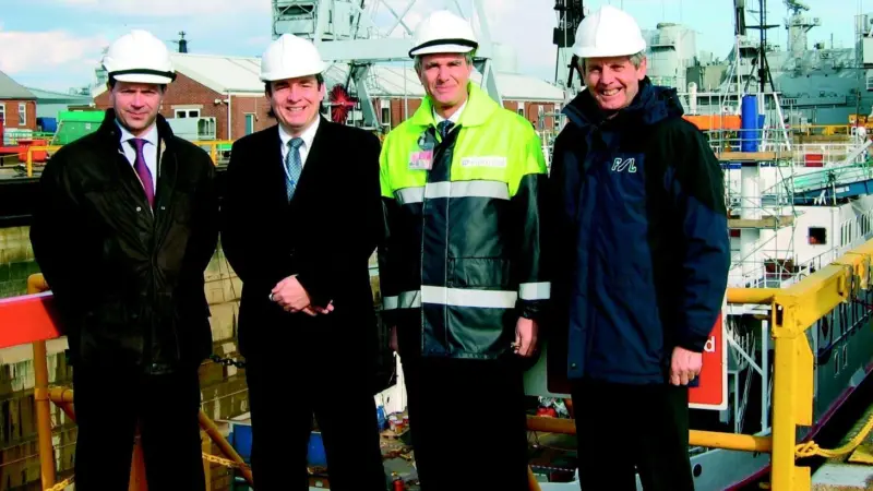 Executives from FSL and Wightlink Marine are seen with the ferry Cenred.