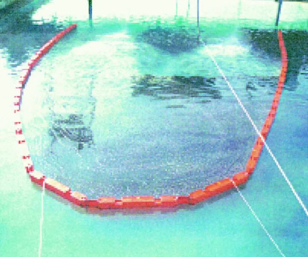 Oil contained in Oil Limiteds rigid boom system during boom performance testing at Ohmsett.