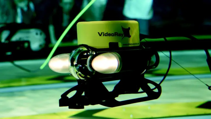 Visitors operate VideoRay Pro III ROVs in an interactive exhibition at ExplorOcean in Plymouth UK.