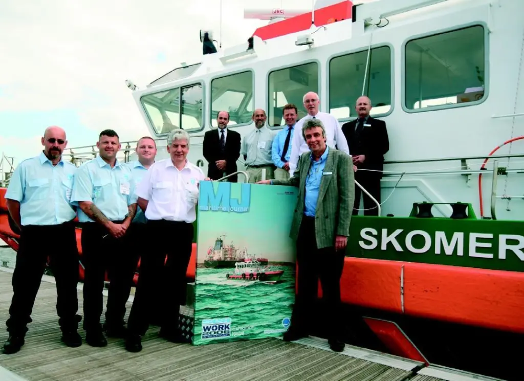 MJs editor presents the canvas to John Littleton of Milford Haven Port Authority, who is flanked by members of the Skomer crew. Also seen are representatives of the vessels builder Mustang Marine and MJs publisher Mercator Media.