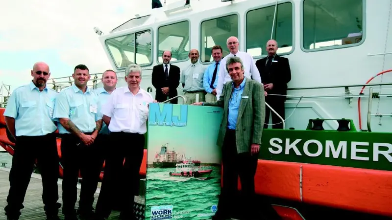 MJs editor presents the canvas to John Littleton of Milford Haven Port Authority, who is flanked by members of the Skomer crew. Also seen are representatives of the vessels builder Mustang Marine and MJs publisher Mercator Media.