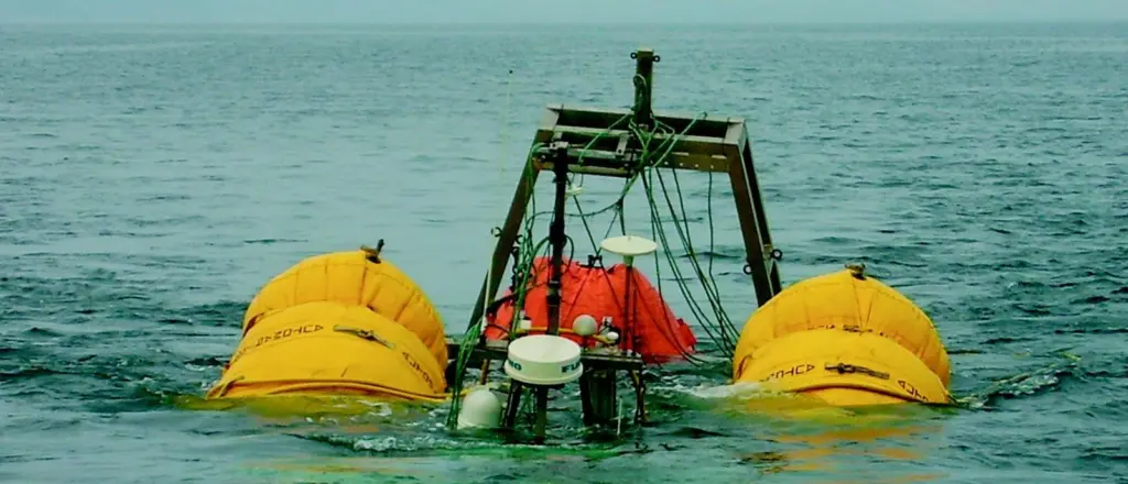 The wreck of the Pamela S on tow into Tenby Harbour supported on lifting bags.