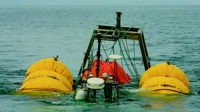 The wreck of the Pamela S on tow into Tenby Harbour supported on lifting bags.