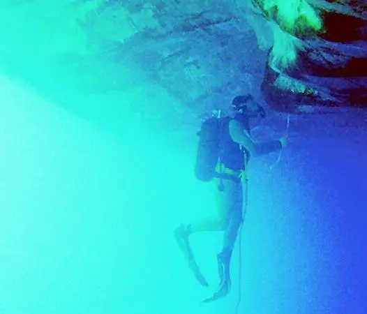A diver inspects the damage.