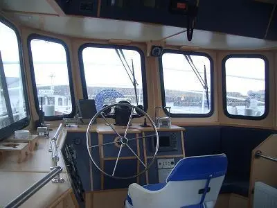 The well appointed wheelhouse features additional seating alongside the helm position.