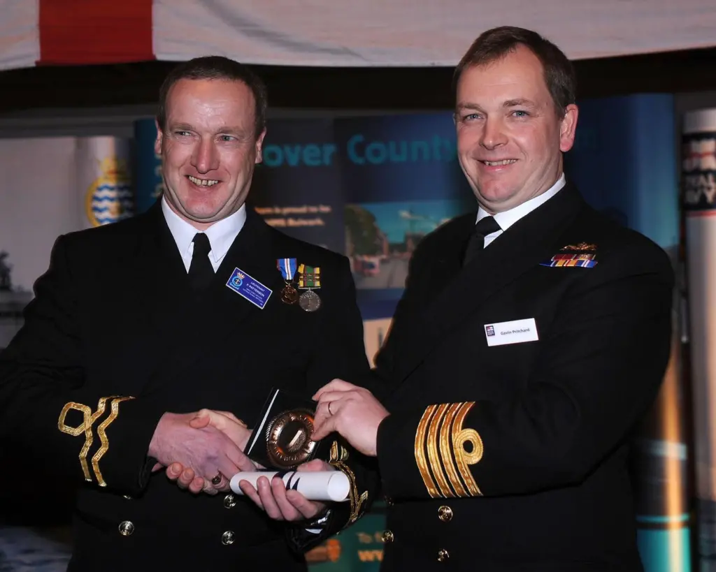 Captain Gavin Pritchard OBE presents a Bravery Medal to Lieutenant Paul Patterson on behalf of the committee of the Tyne Lifeboat Society