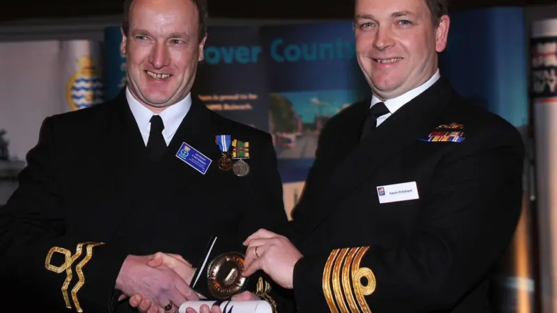Captain Gavin Pritchard OBE presents a Bravery Medal to Lieutenant Paul Patterson on behalf of the committee of the Tyne Lifeboat Society