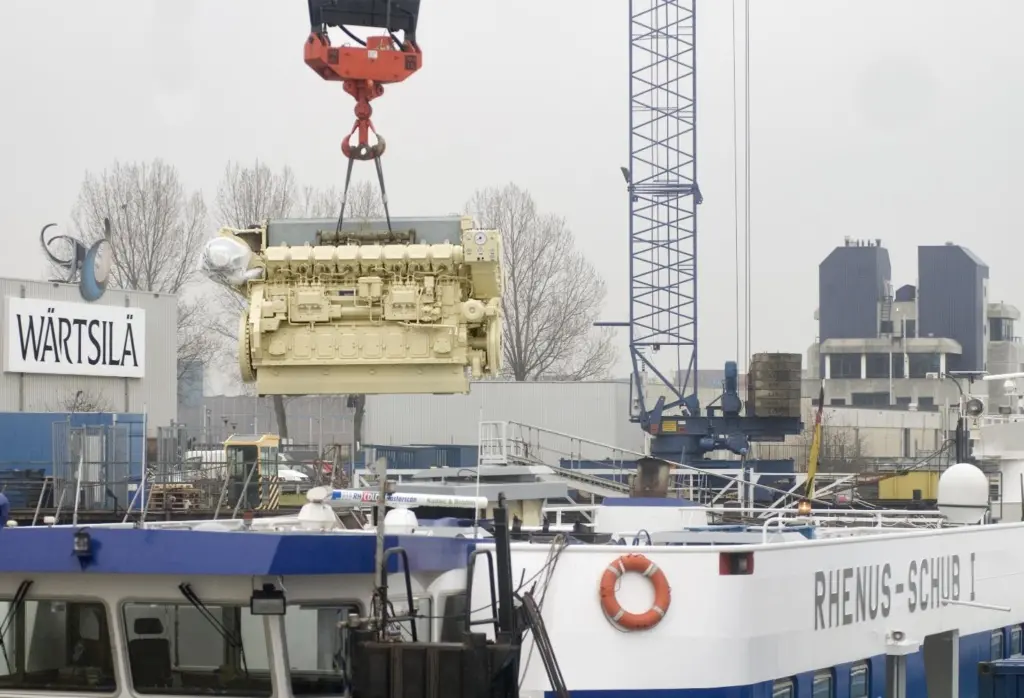 The newly remanufactured engine is lifted into position.