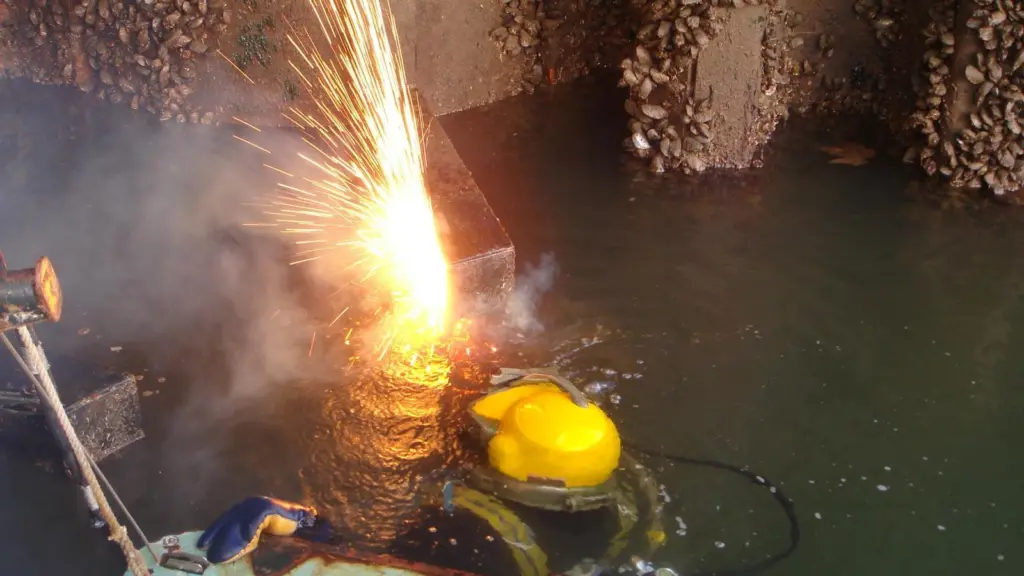 A Seawork Marine Services diver performs underwater burning work at a container port.