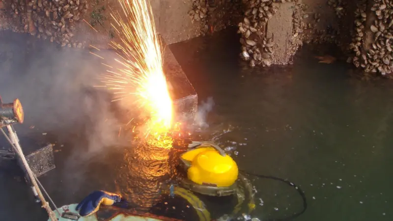 A Seawork Marine Services diver performs underwater burning work at a container port.