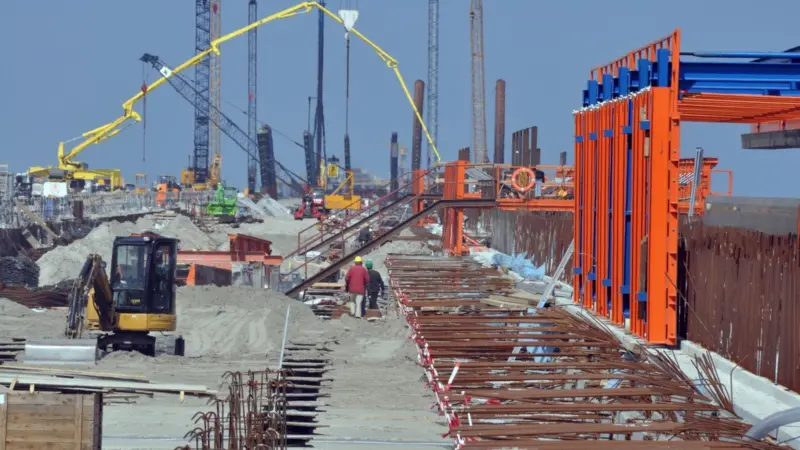 Local officials and the future operators of JWP are in dispute over when it will be completed.