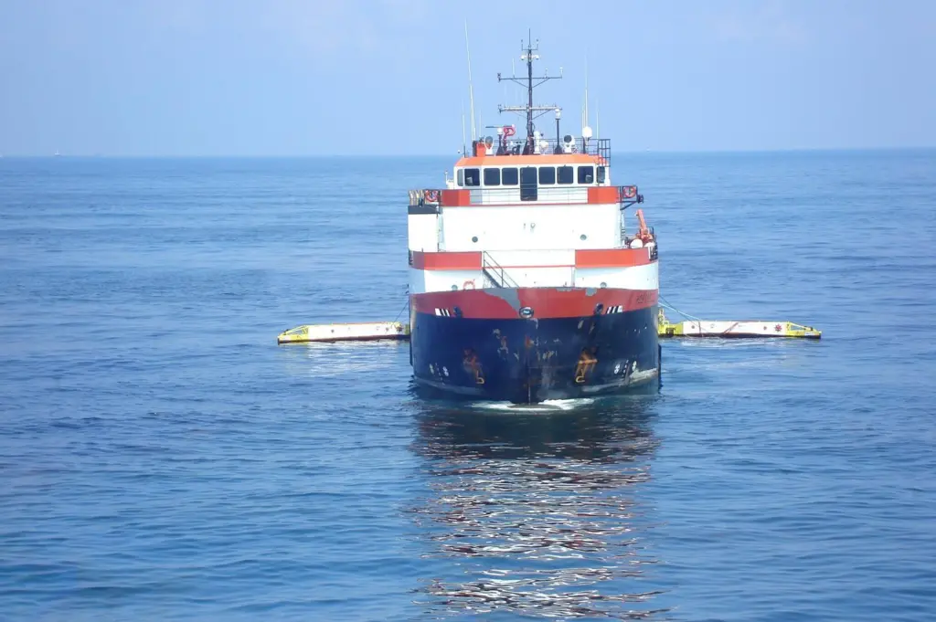 A sweeping arm system fitted to a commercial vessel collects oil in the Gulf of Mexico.