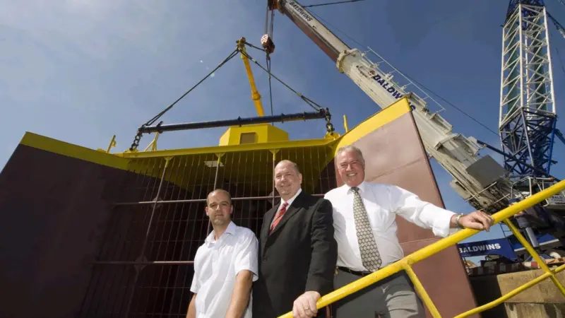 Cllr Paul Watson (centre) meets Jonathan (left) and Harry Wilson of Wear Dock and Engineering before the generator set sail.
