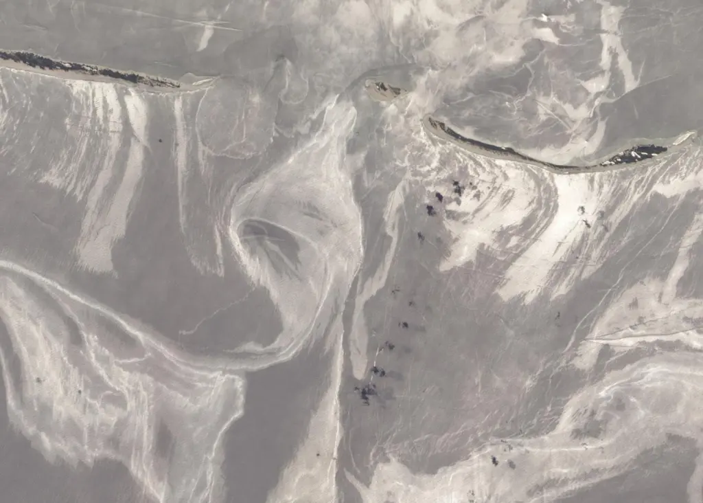 The slick around the Mississippi Barrier Islands in late June. Oil covered waters are silvery in colour. Photo: NASA