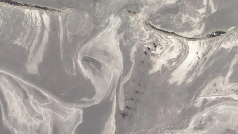 The slick around the Mississippi Barrier Islands in late June. Oil covered waters are silvery in colour. Photo: NASA
