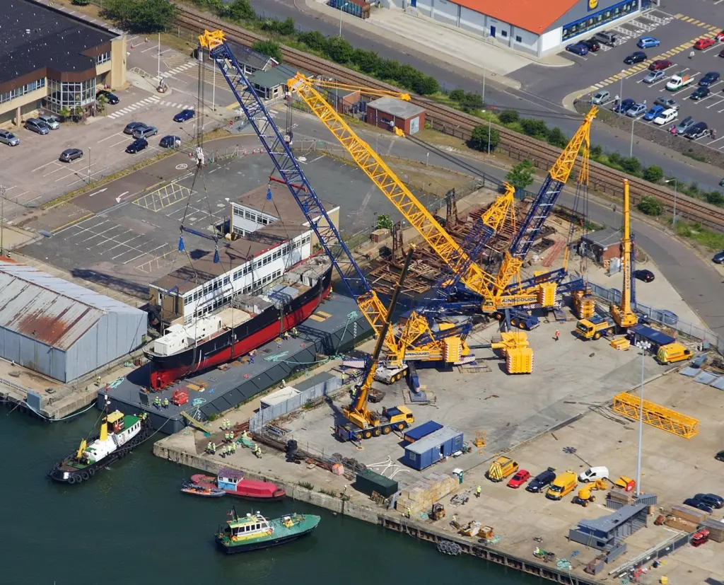 Cranes prepare to lift SS Robin, which has recently been restored in Lowestoft UK. Photo: Skyview/Mike Page