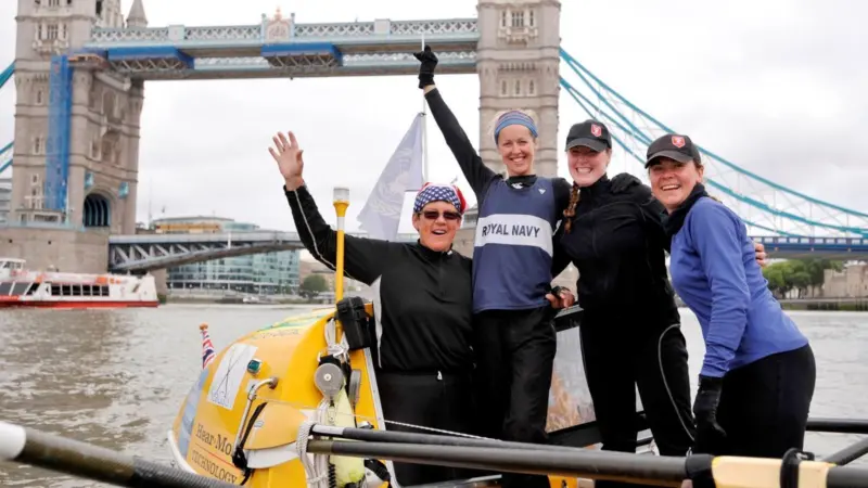 The successful team complete their row at London’s Tower Bridge on Sunday morning.