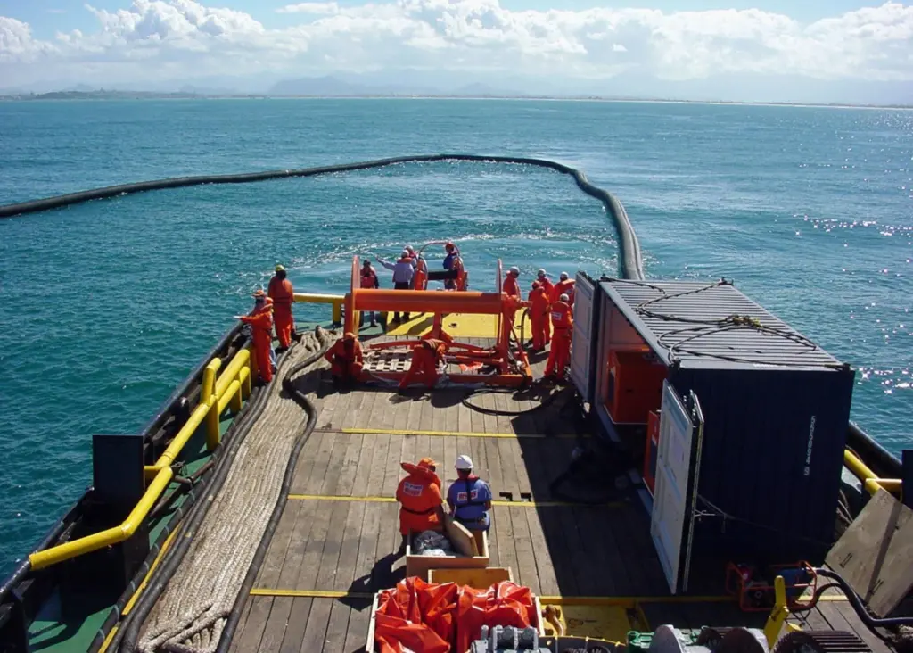 A Vikoma Weir Boom is seen both containing and recovering oil.