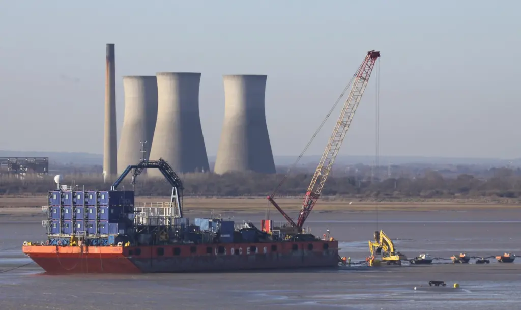 The barge UR101 is seen beached in Pegwell Bay earlier this year while carrying out the shore landing of the export cable for the Thanet Offshore Wind Farm. Photo by Peter Barker