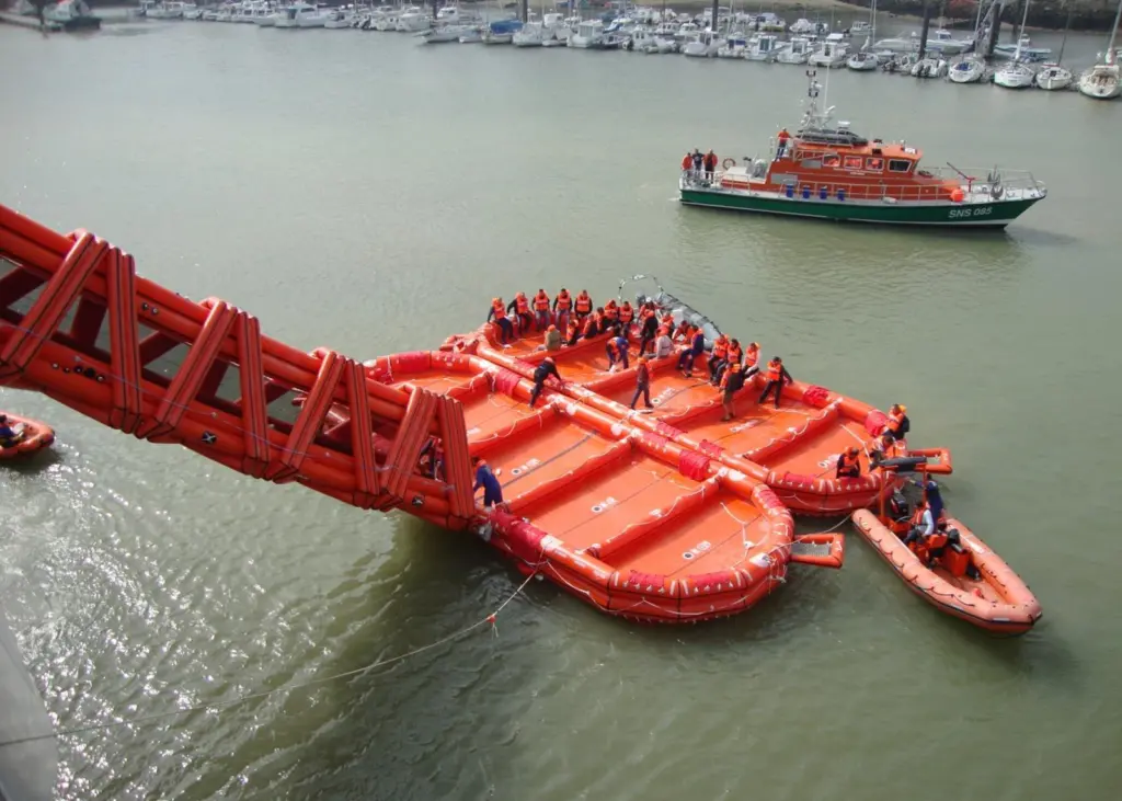 The rescue RIB prepares to tow the first of the two liferafts clear of the ferry.
