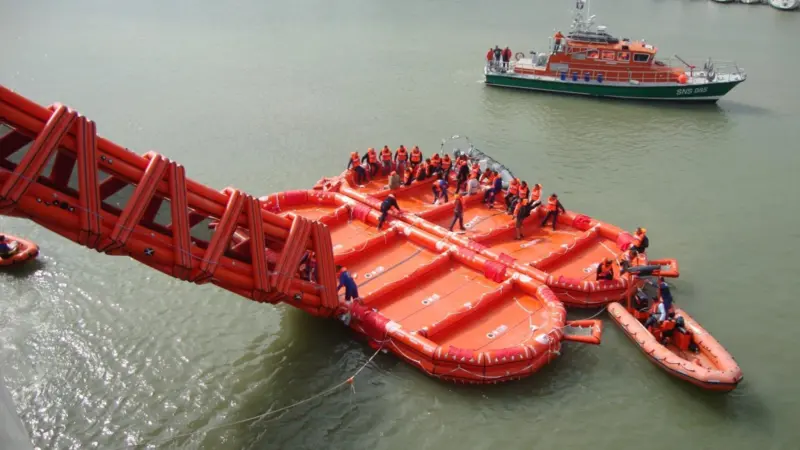 The rescue RIB prepares to tow the first of the two liferafts clear of the ferry.
