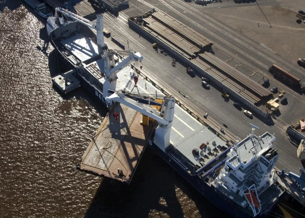 MV Beluga Stavanger is seen loading the construction barge Kurt in the port of Brake.