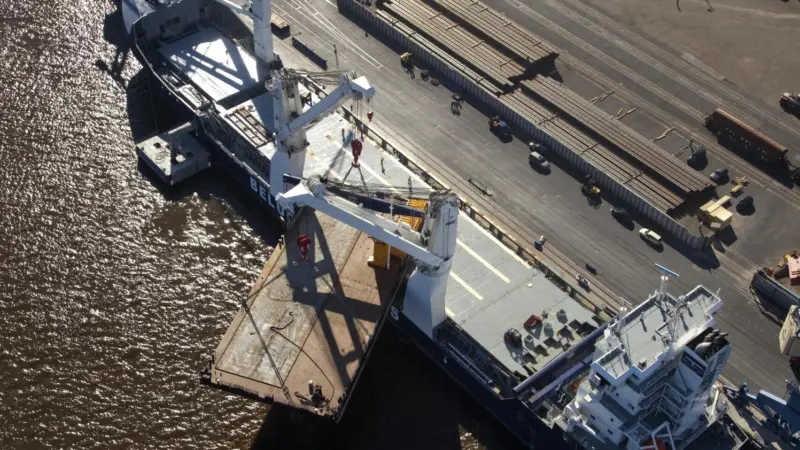 MV Beluga Stavanger is seen loading the construction barge Kurt in the port of Brake.