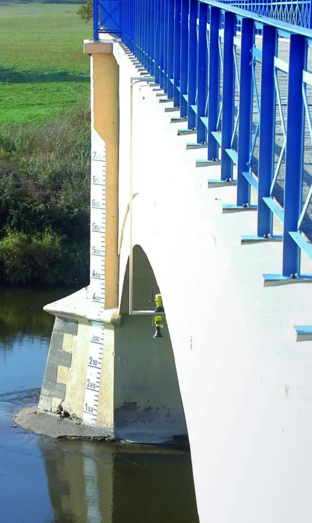 The new water level measurement radar is seen positioned to monitor possible flood conditions in a river environment.
