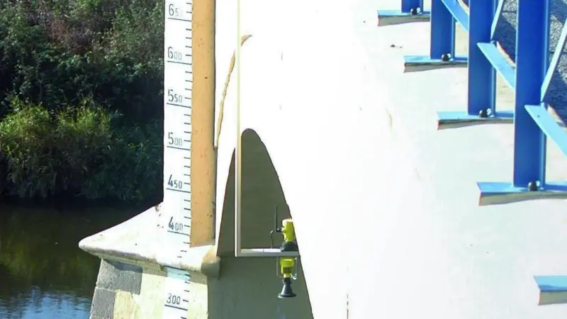 The new water level measurement radar is seen positioned to monitor possible flood conditions in a river environment.
