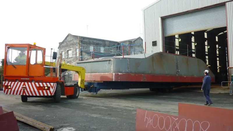 The hull of the first Mustang built Damen Multicat is manoeuvred at the Pembroke Dock shipyard.