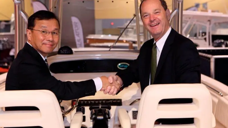 Takaaki Kimura, senior managing executive officer of Yamaha Motor and Volvo Penta CEO Göran Gummeson shake hands at the Miami Boat Show 2011.