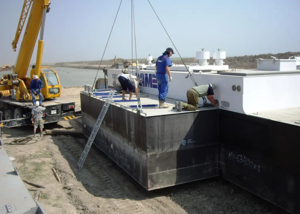 A Damen field service engineer surveys the on-site assembly of the dredger.