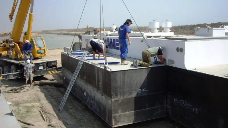A Damen field service engineer surveys the on-site assembly of the dredger.