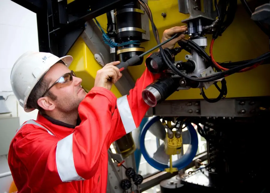 An S³ ROV Pilot technician adjusting the camera pan and tilt unit on an S³ ROV.