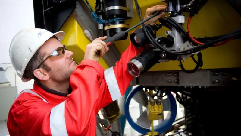 An S³ ROV Pilot technician adjusting the camera pan and tilt unit on an S³ ROV.