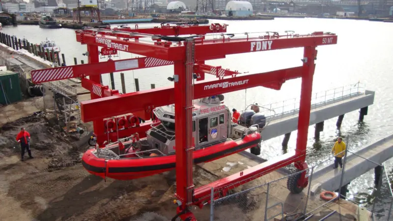 The 50 BFMII mobile boat hoist has custom built spreaders to allow foam collared vessels to be lifted by a single pick point.