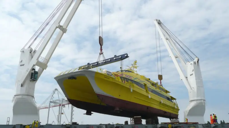 One of the refiitted Fastcats is lifted onto OXL Fantasy in the Port of Southampton.