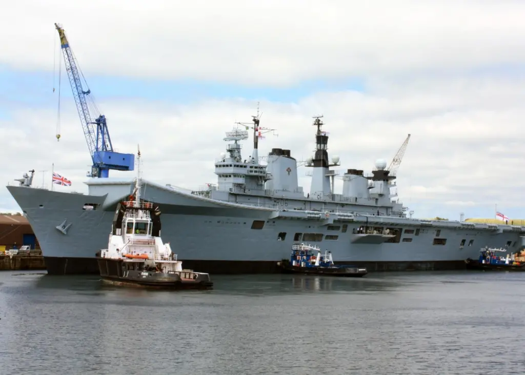 Tugs prepare to assist Illustrious as it left Rosyth for sea trials.