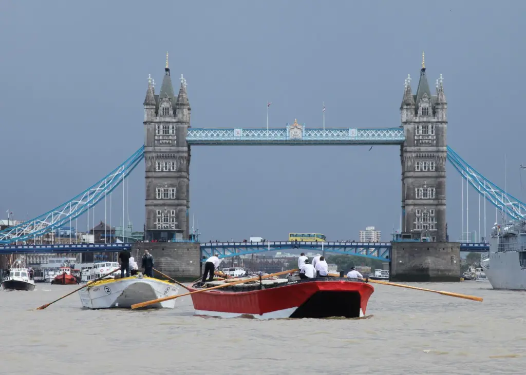 Barges at close quarters as they clear Tower Bridge.