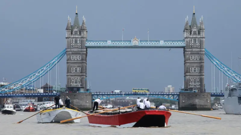 Barges at close quarters as they clear Tower Bridge.