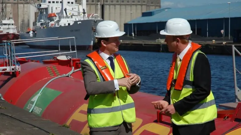UK Climate Change Minister Greg Baker with Pelamis Wave Power CTO Richard Yemm on the quayside at Leith Docks.