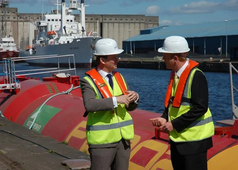 UK Climate Change Minister Greg Baker with Pelamis Wave Power CTO Richard Yemm on the quayside at Leith Docks.