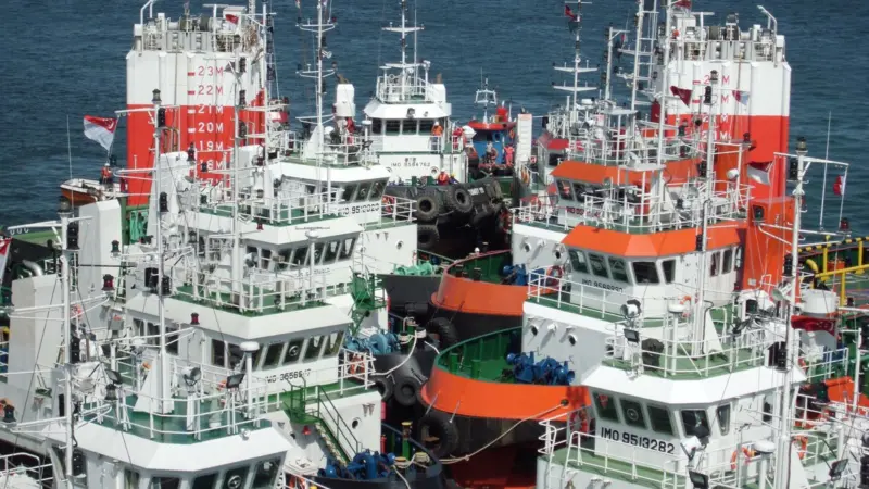 A view from the bridge of the heavy lift ship Fjell shows 16 tugs on the cargo deck.