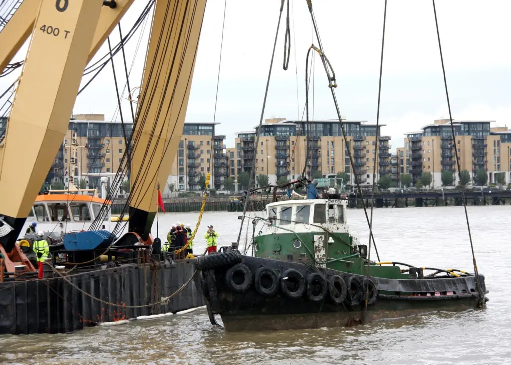The ill fated Chiefton is cradled in the slings of the floating sheerlegs GPS Apollo shortly after the parbuckling operation to bring it upright.