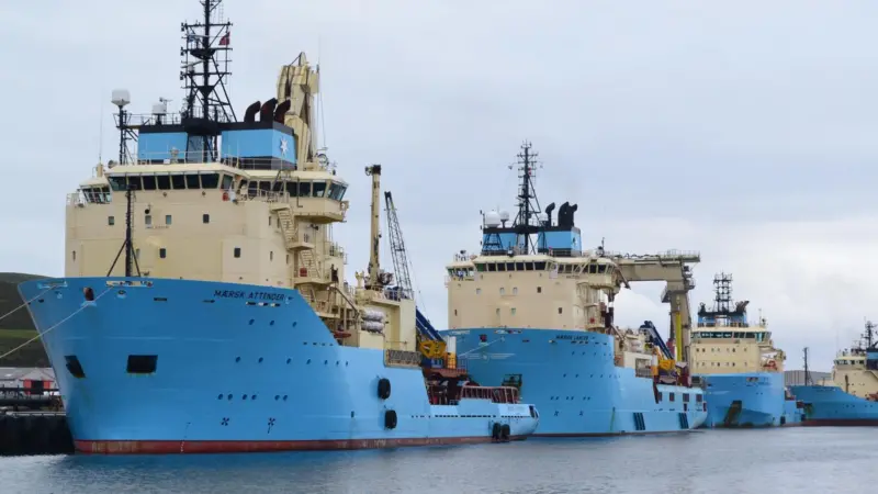 Offshore oil and gas industry vessels crowd Lerwick Harbour in Shetland.