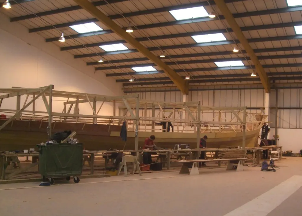 The vessel is being built at a fast pace, with two shifts of 14 craftsmen each working a six day week.